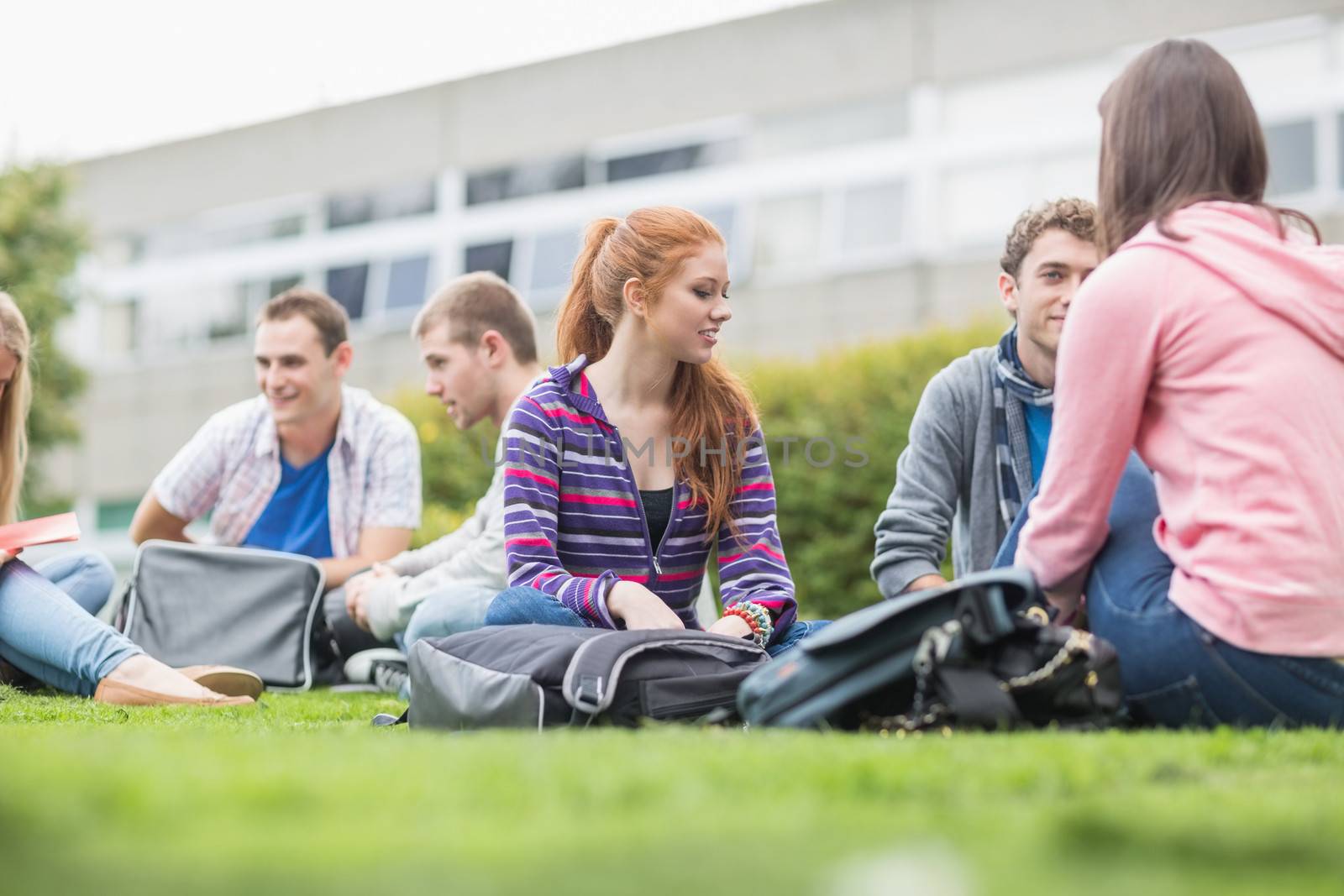 College students sitting in the park by Wavebreakmedia