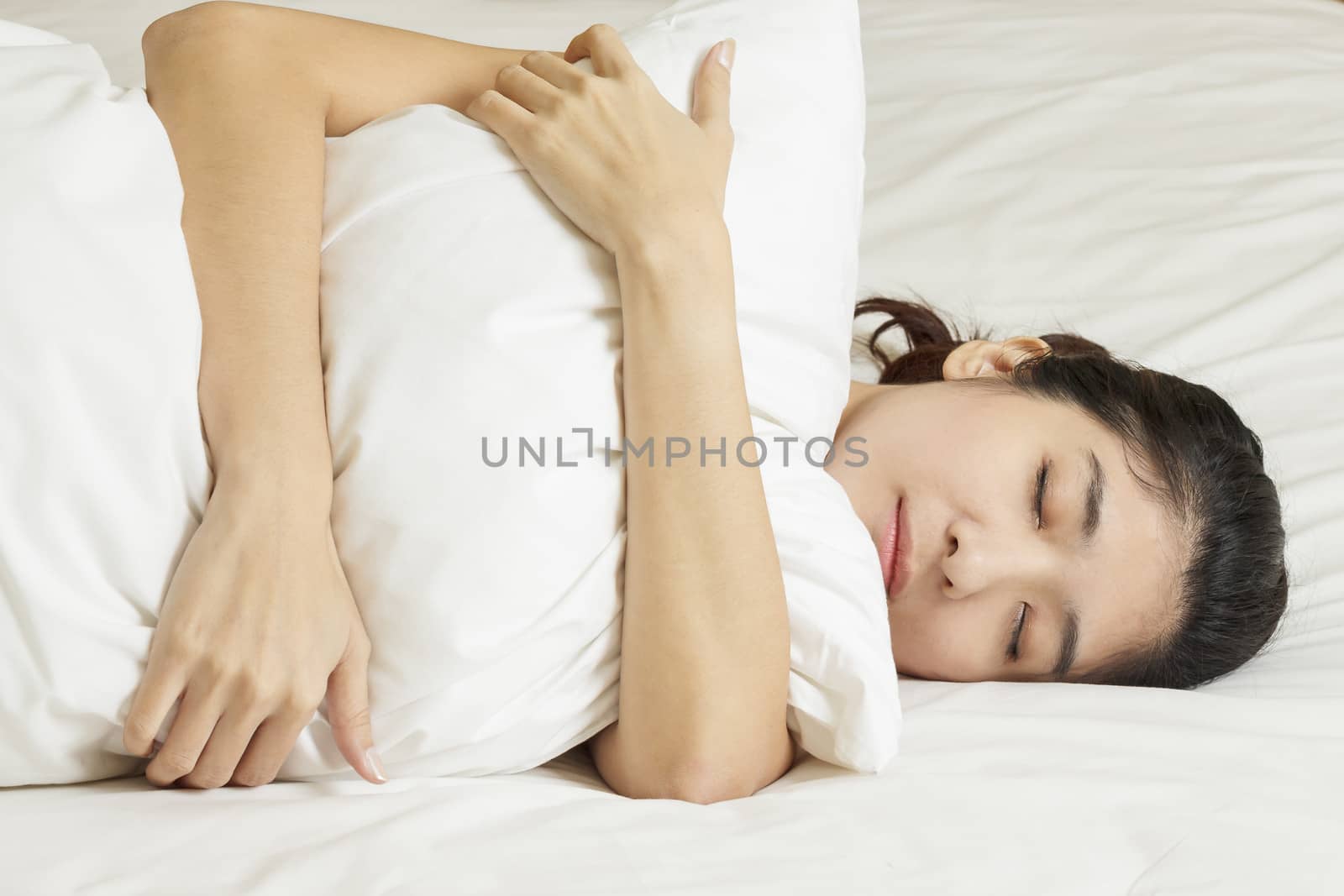 young beautiful woman sleeping in bed by FrameAngel