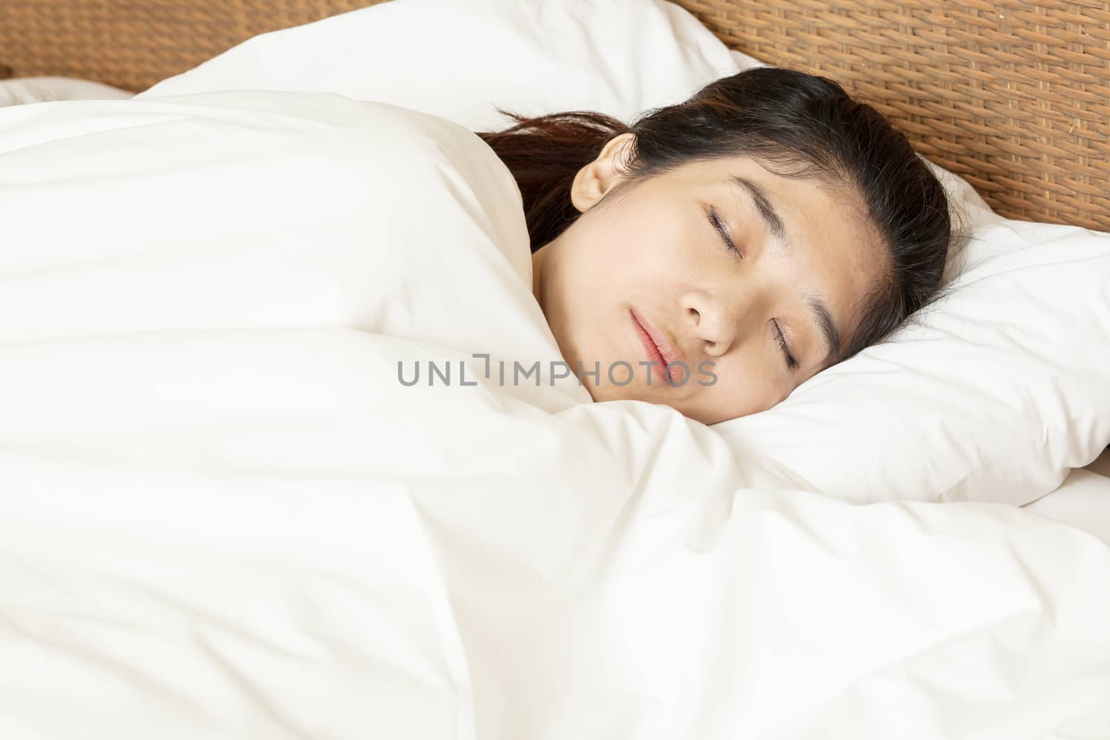 young beautiful woman sleeping in bed by FrameAngel