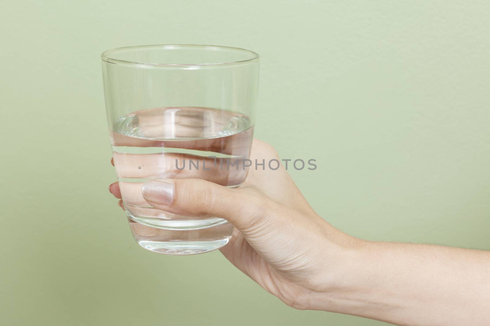Woman hand with glass of water