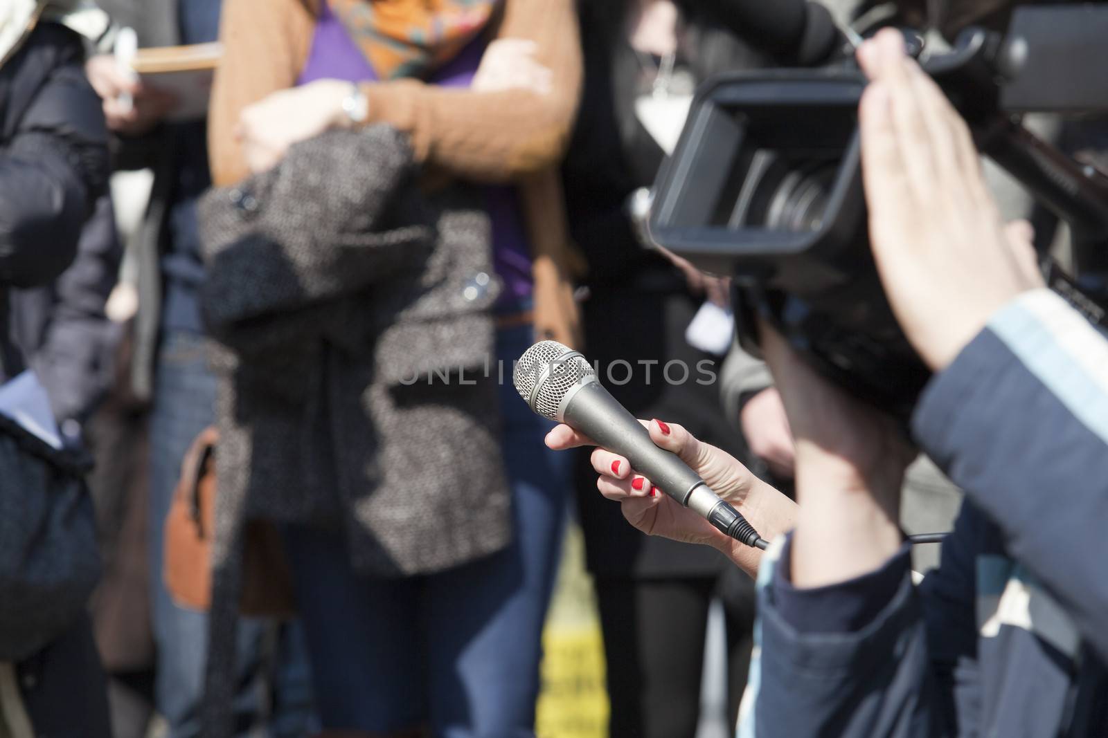 A journalist is making a interview with a microphone