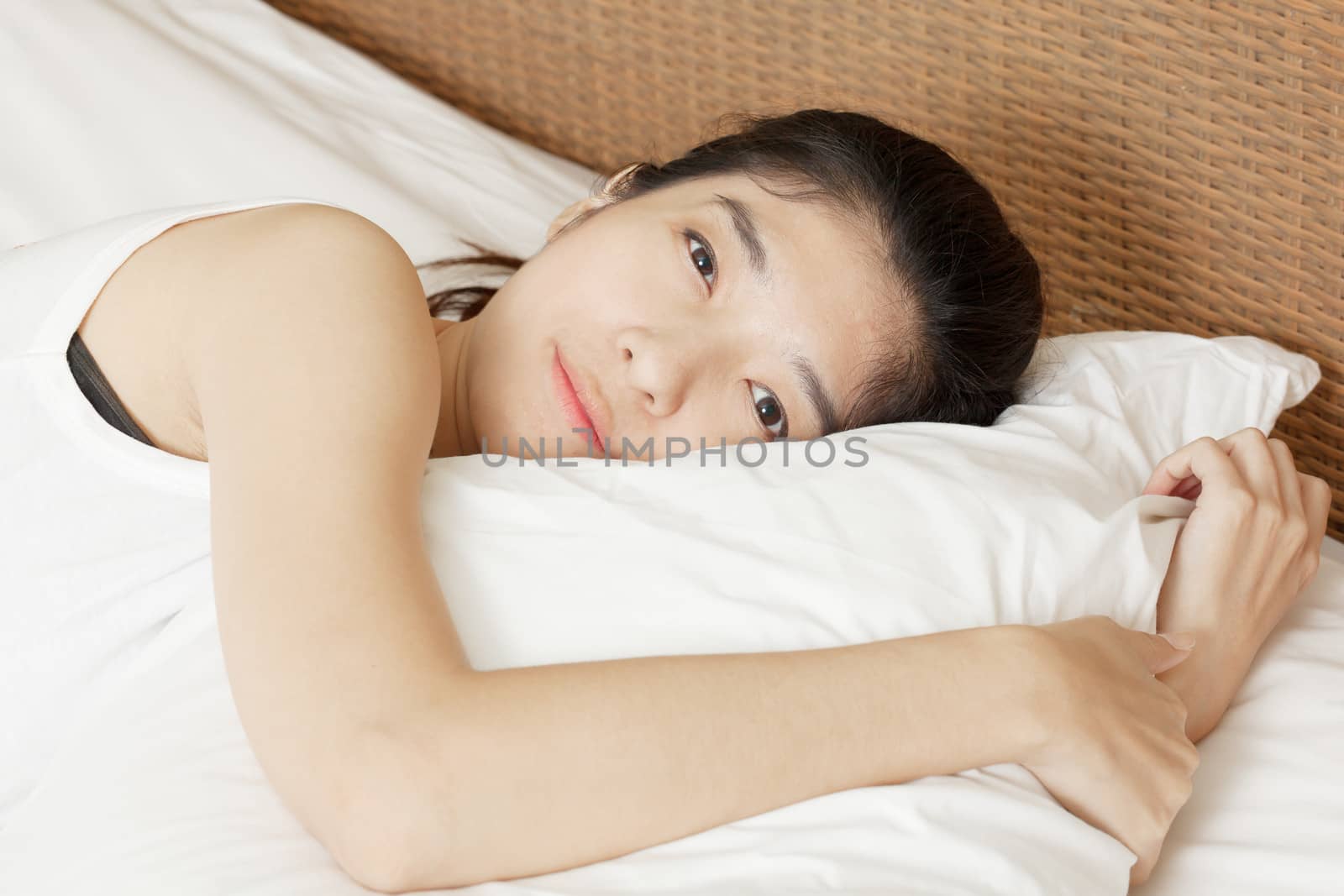 young beautiful woman sleeping in bed, in morning by FrameAngel