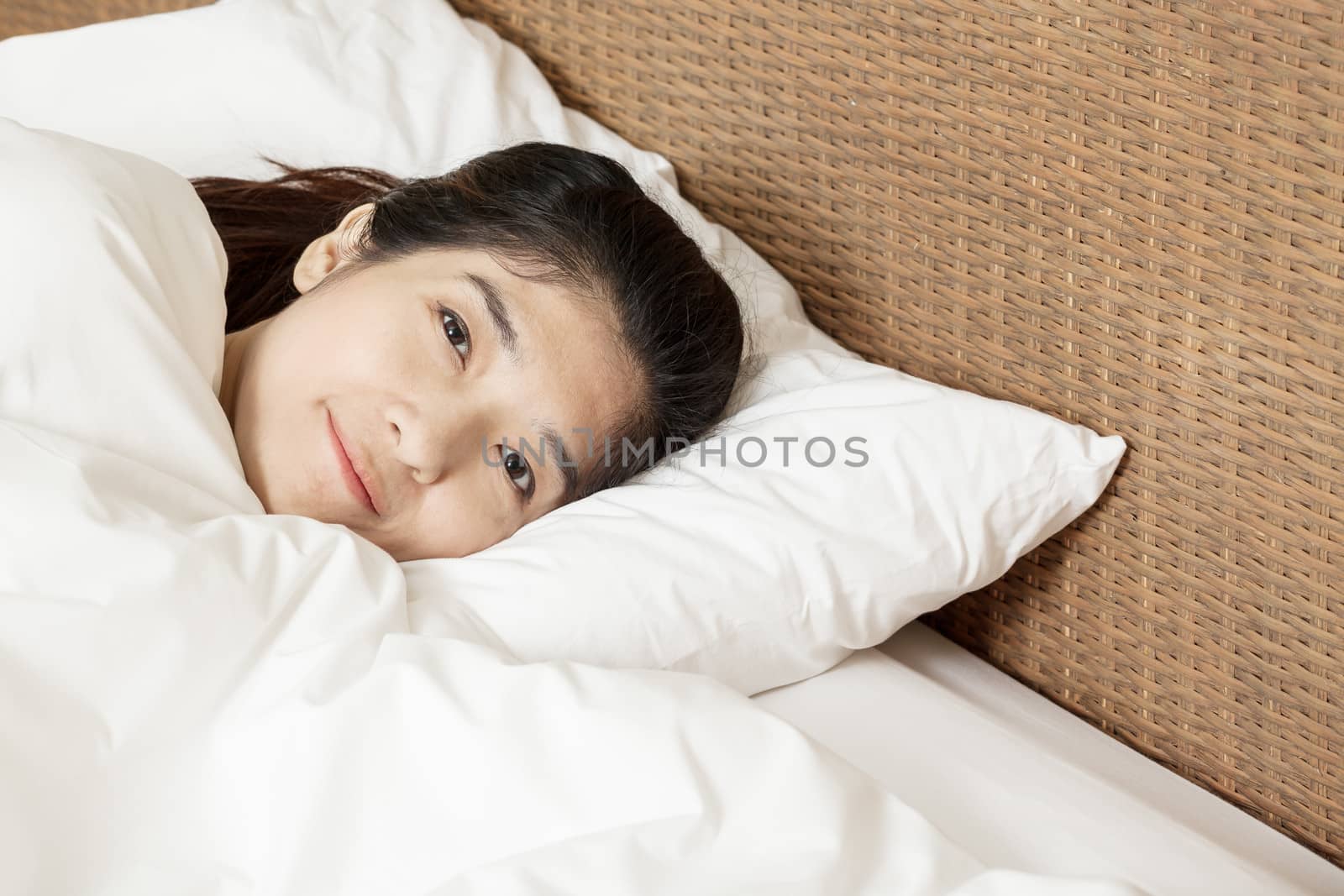 young beautiful woman sleeping and smile in morning by FrameAngel