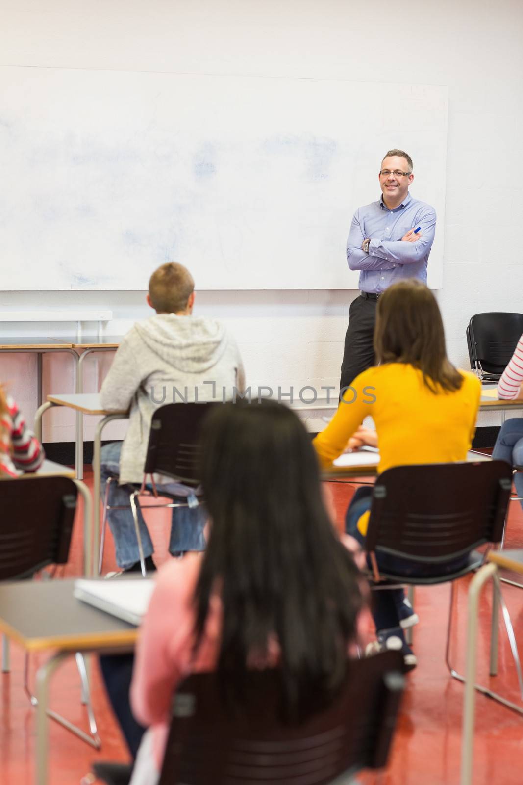 Attentive students with teacher in the classroom by Wavebreakmedia