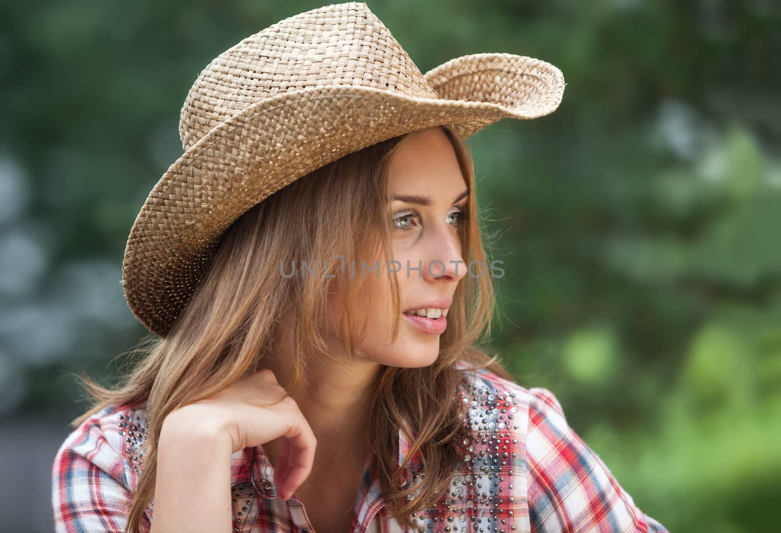 Sexy cowgirl. Young woman portrait in a hat