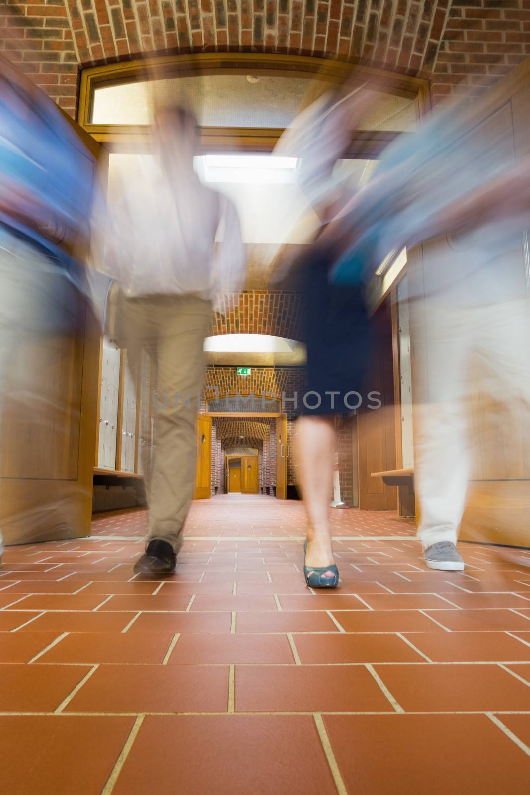 Low angle view of a group of blurred people walking through open doors