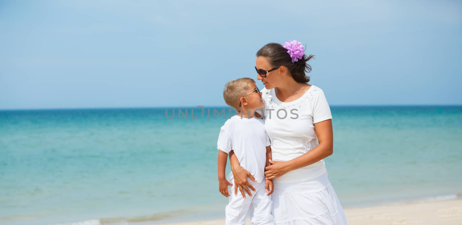 Mother and son having fun on tropical beach