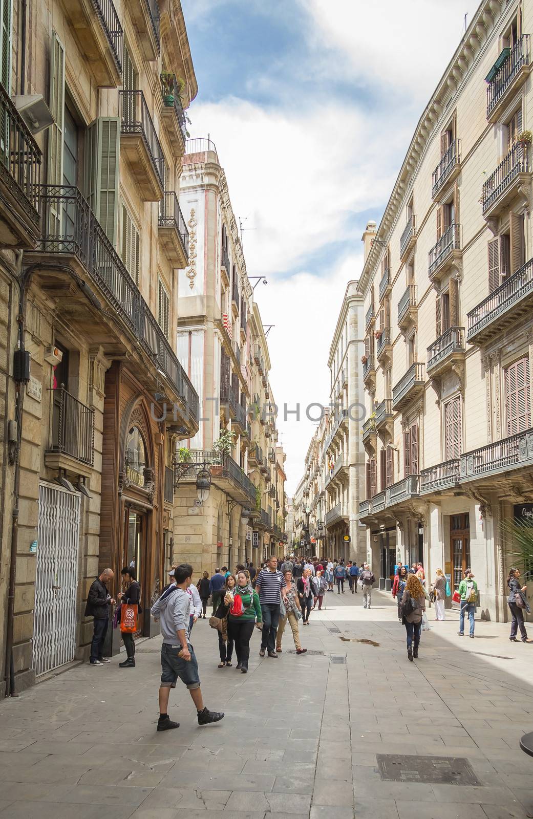 BARCELONA, SPAIN - MAY 31 People walking near the famous modernist facade of traditional philately shop, in Barcelona, Spain, on May 31, 2013