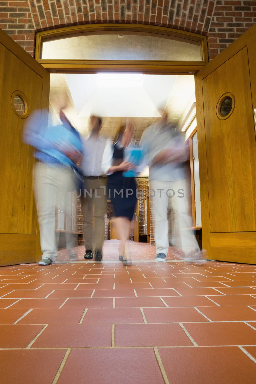 Blurred people walking through open doors by Wavebreakmedia