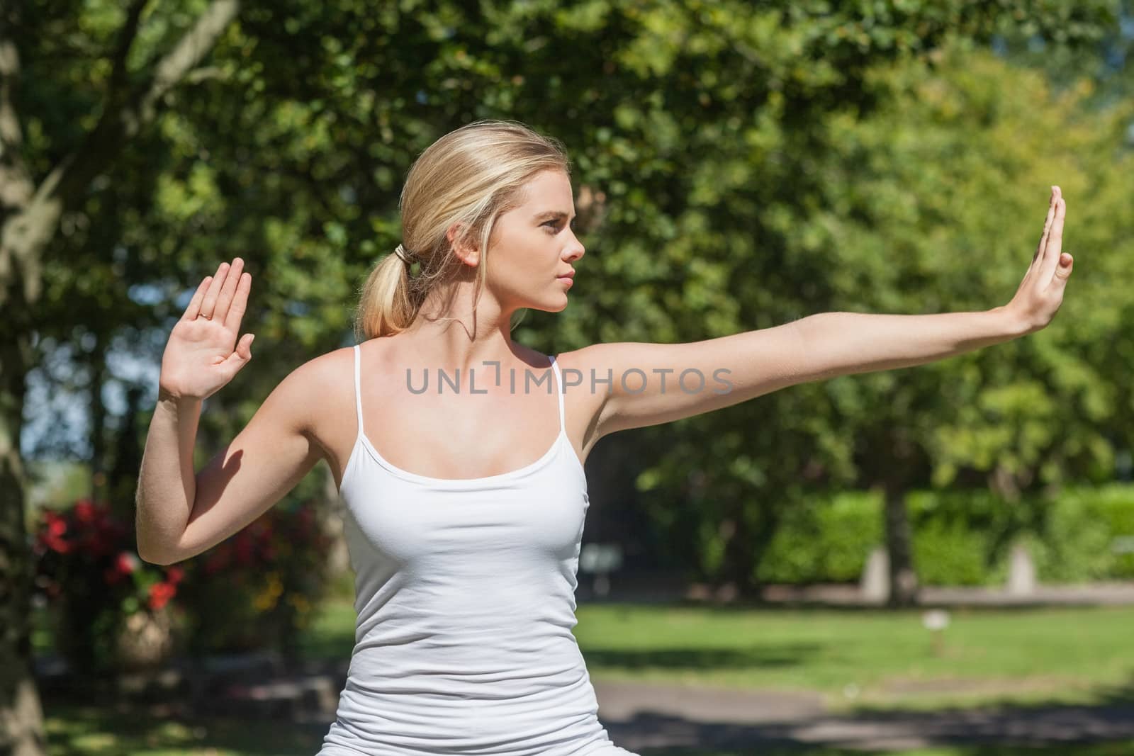 Concentrated young woman doing yoga by Wavebreakmedia