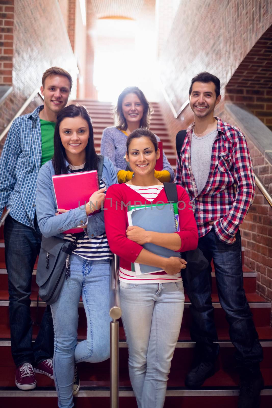 College students standing on stairs in college by Wavebreakmedia