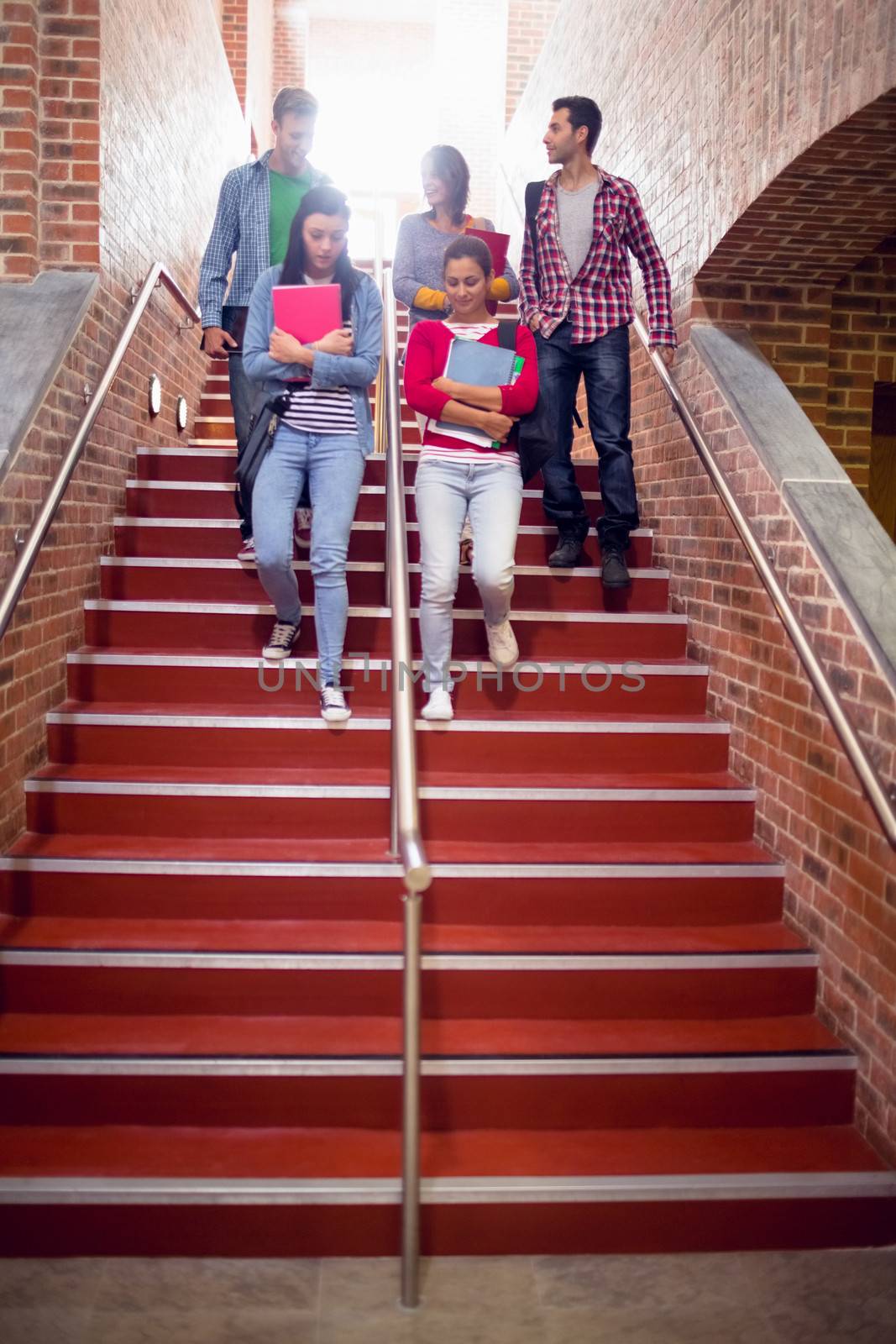 College students walking down stairs in college by Wavebreakmedia