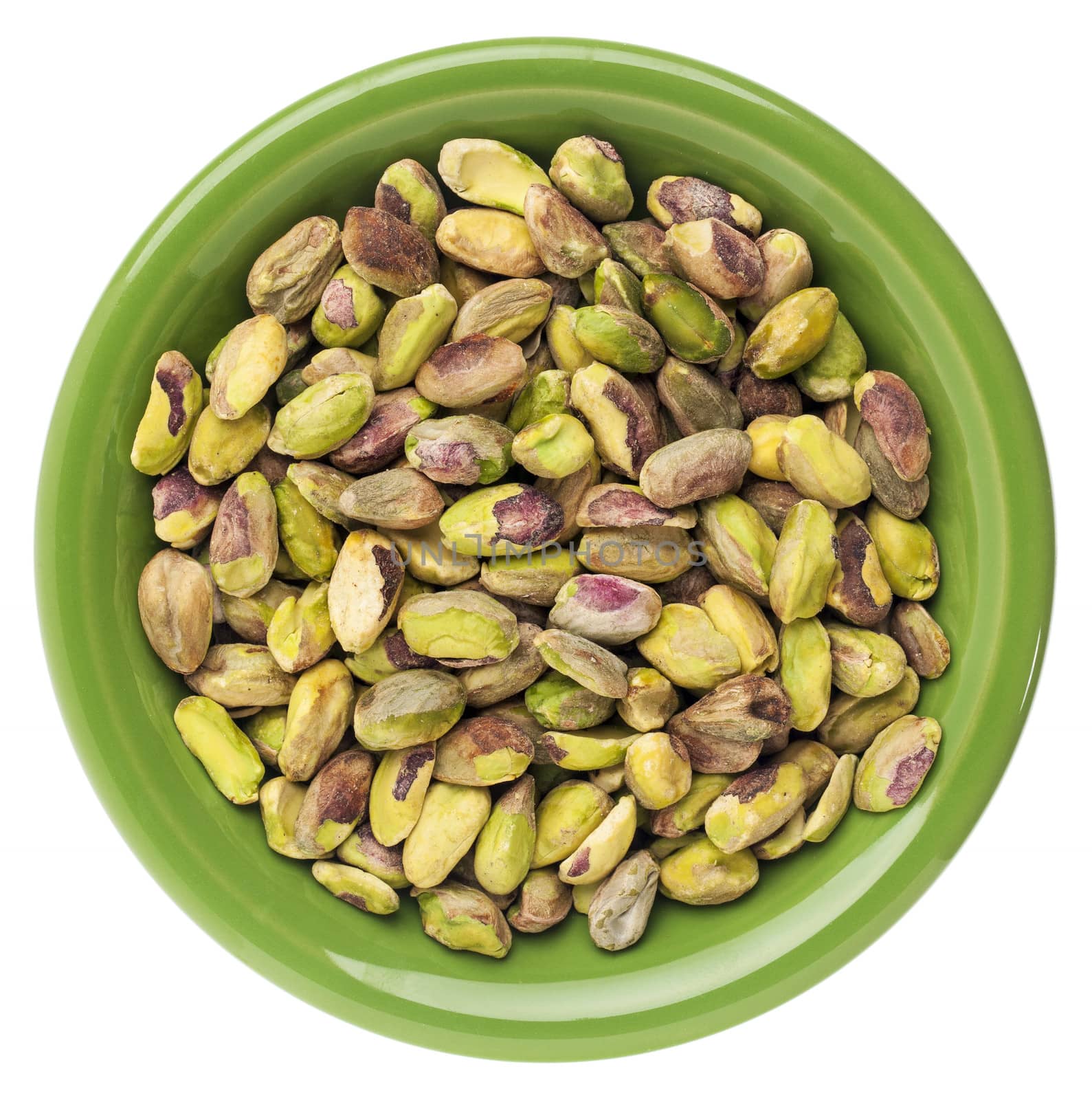 a small bowl of raw shelled pistachio nuts isolated on white,