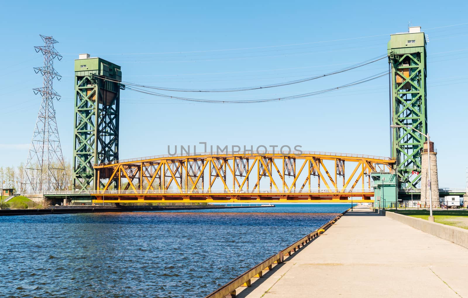 The Burlington Canal Lift Bridge is located on the western shore of Lake Ontario. The bridge spans the Burlington Canal that was opened in 1826. The bridge structure is a tower driven, vertical lift and moveable bridge. The lift span is 116 metres long, weighs 1,996 tonnes and has a vertical lift of 33.5 metres.