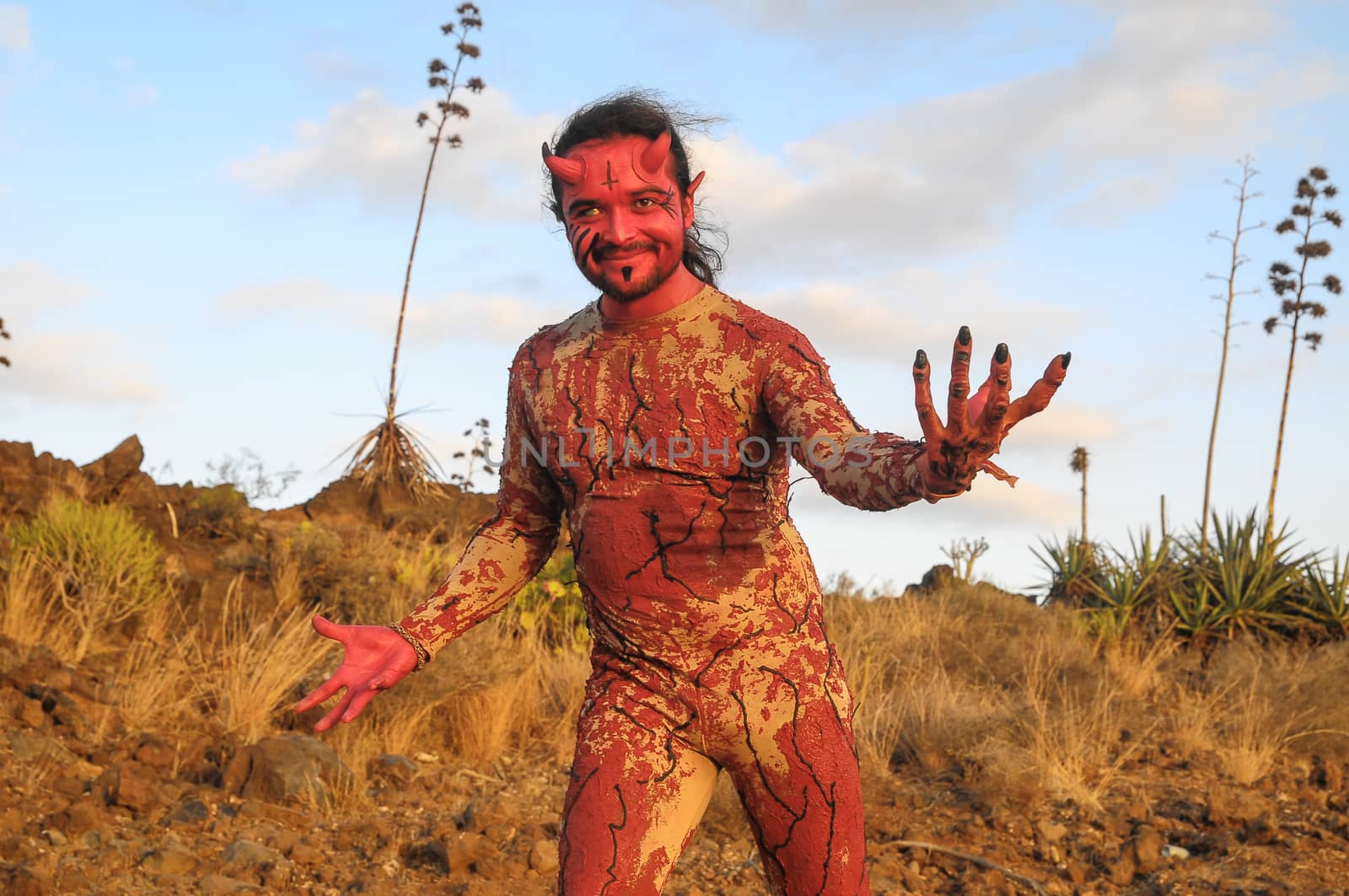 Latin American Man with Long Hairs Masked as a Devil in the Desert