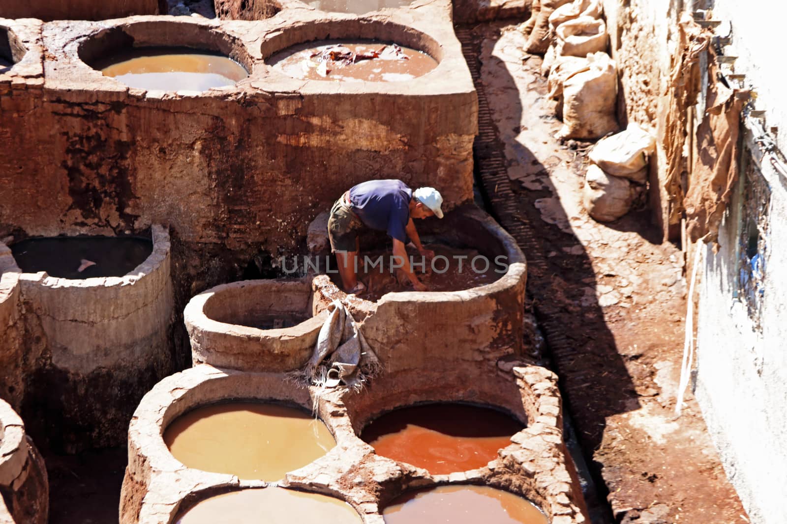 FES - OCTOBER 17: Morrocan man working dying skins in a Fes tannery October 17, 2013 in Fes, Morocco.