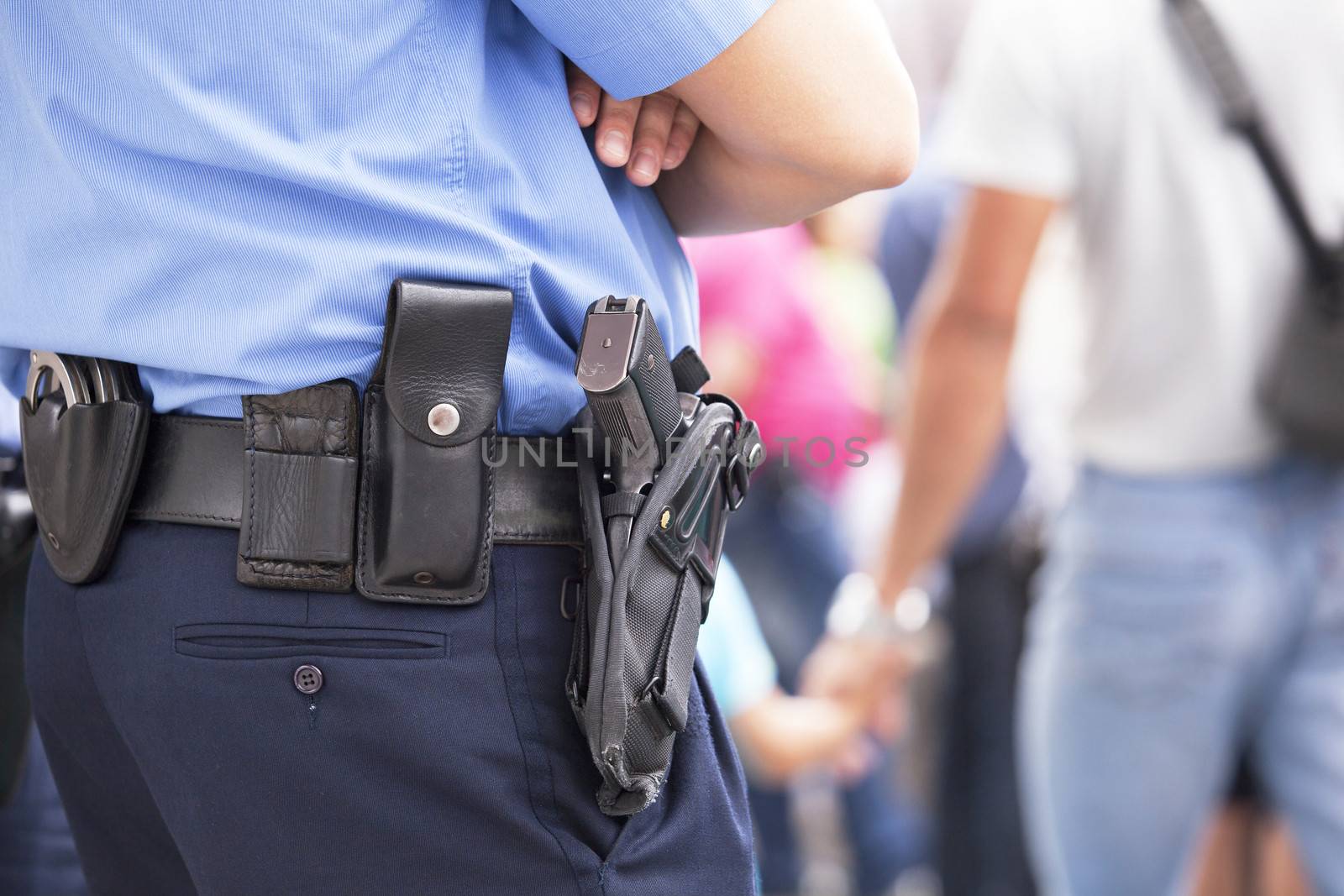 Police officer with handgun on his holster