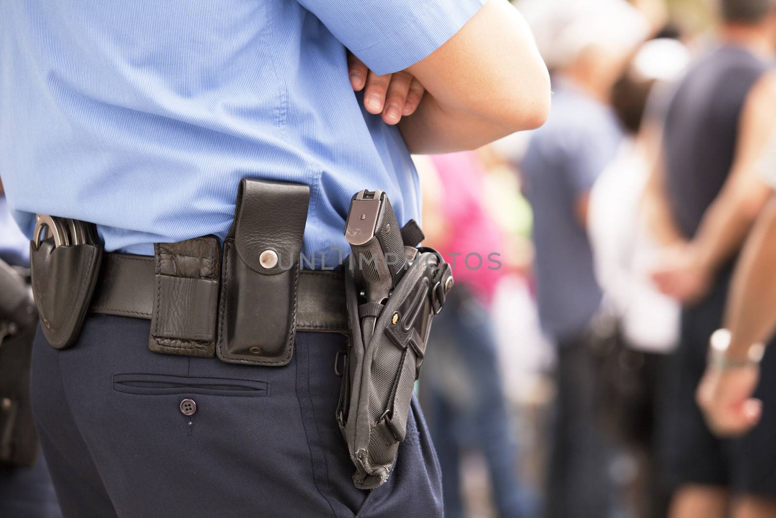 Police officer with handgun on his holster