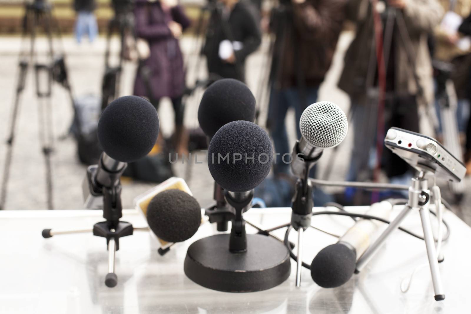 A microphone on a stage in front of audience