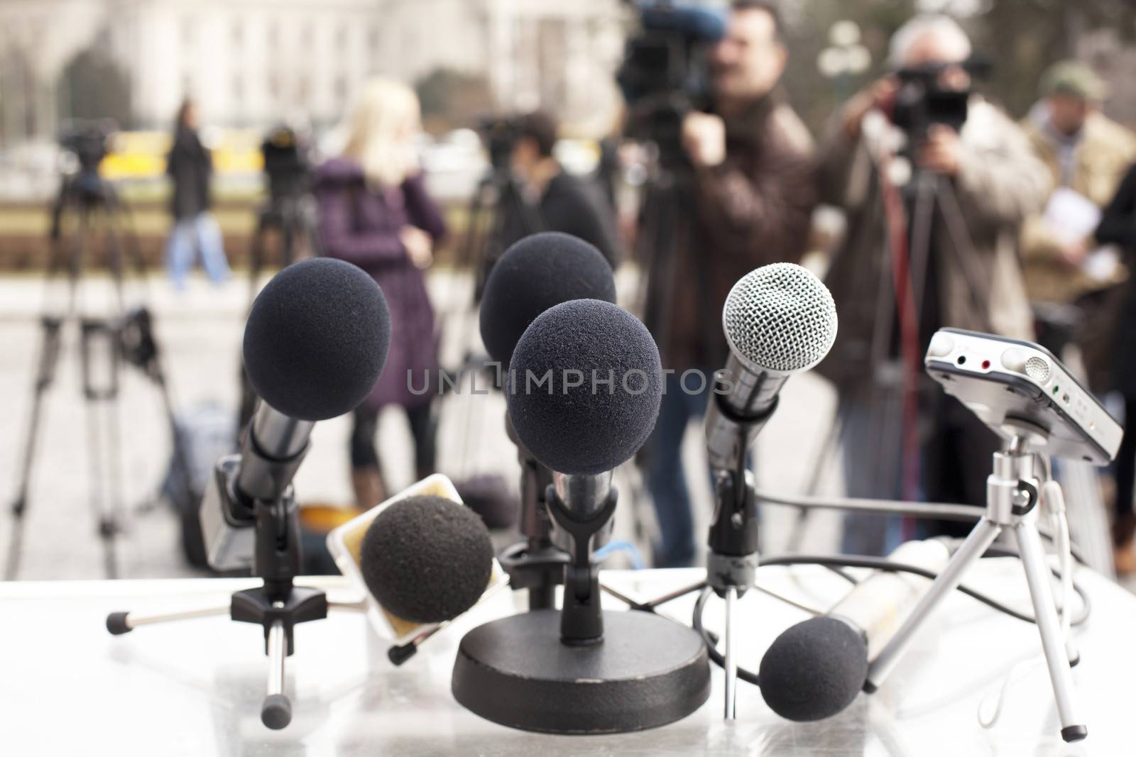 A microphone on a stage in front of audience