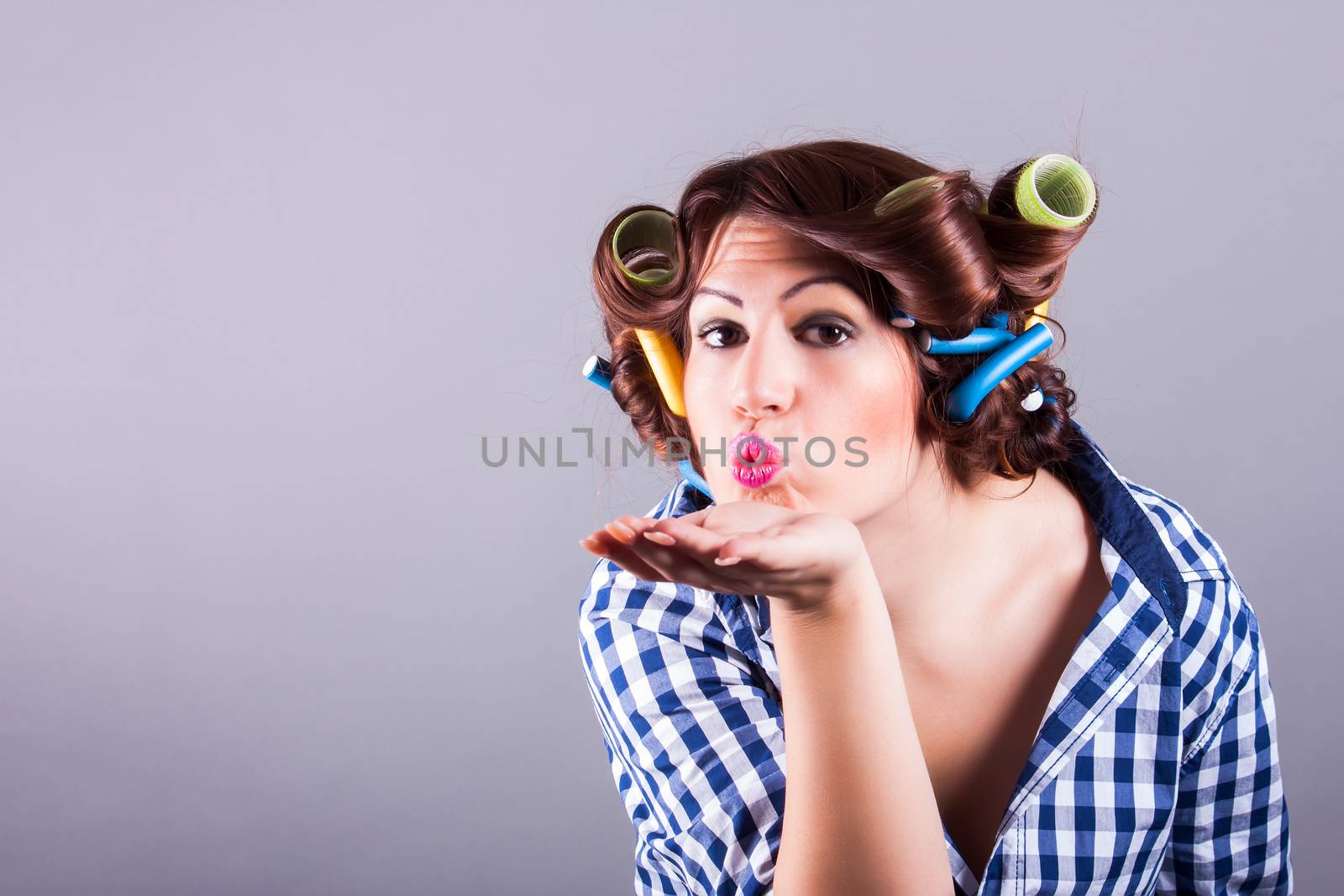 portrait of sexy housewife with curlers. pin up portrait