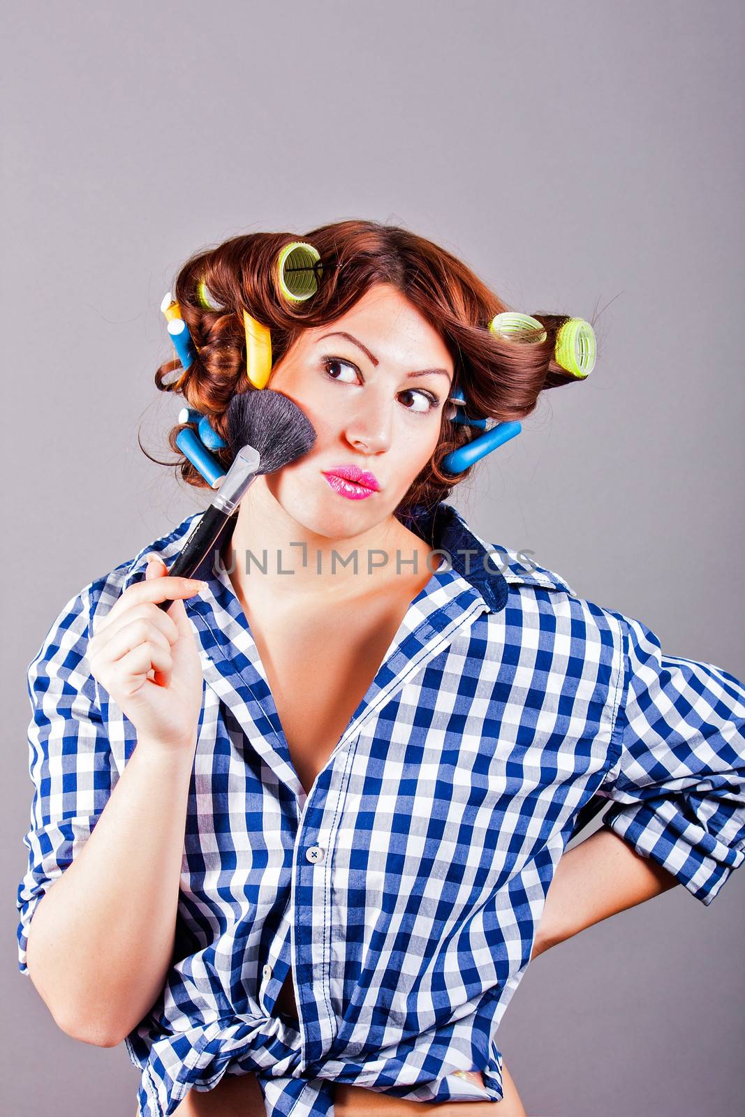 portrait of sexy housewife with curlers. pin up portrait