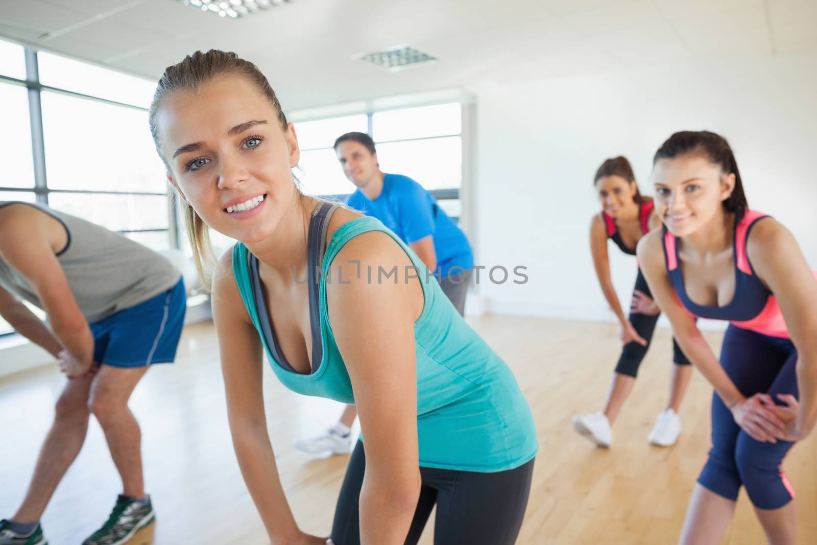 Fitness class and instructor doing power fitness exercise by Wavebreakmedia