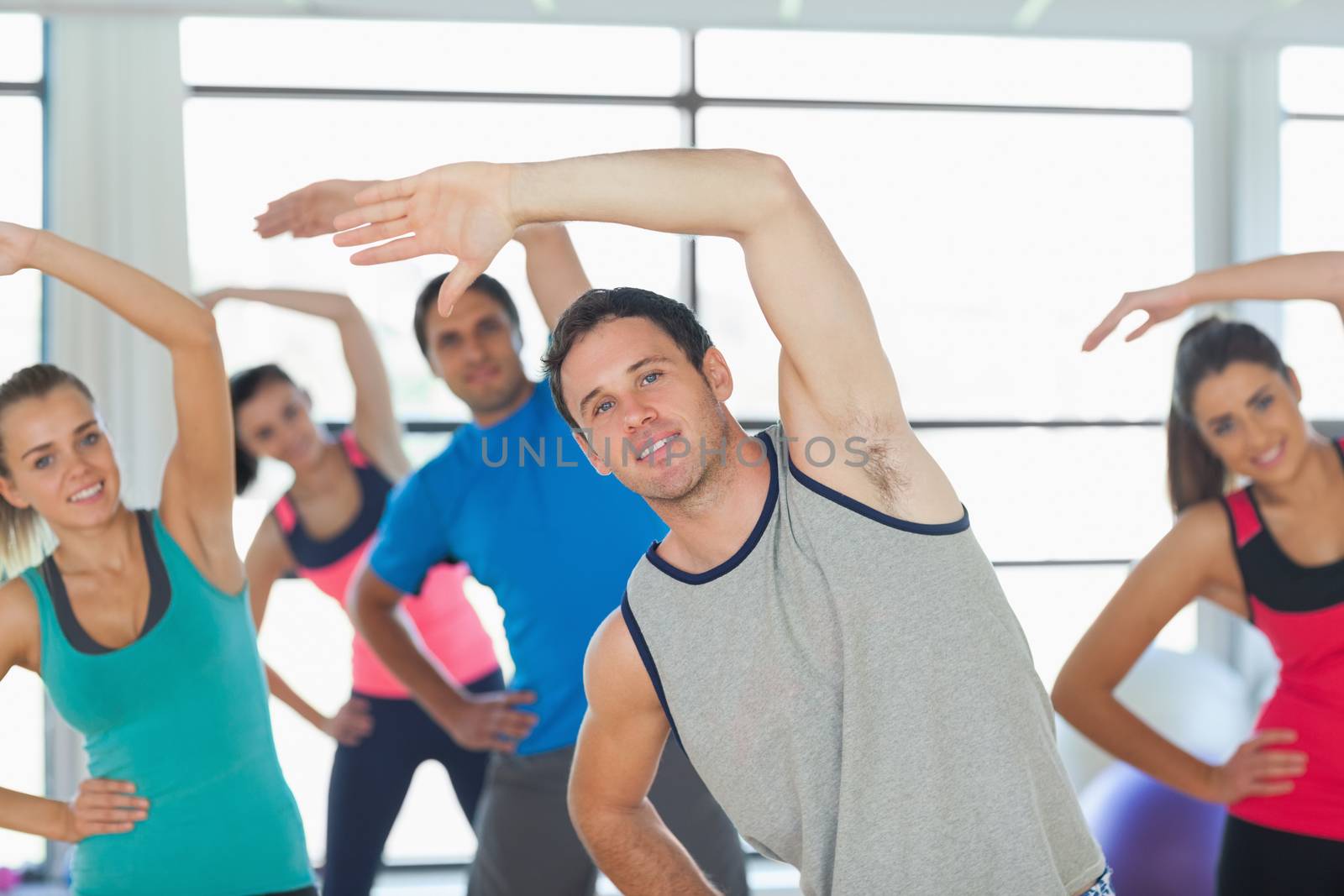 Portrait of sporty people doing power fitness exercise at yoga class