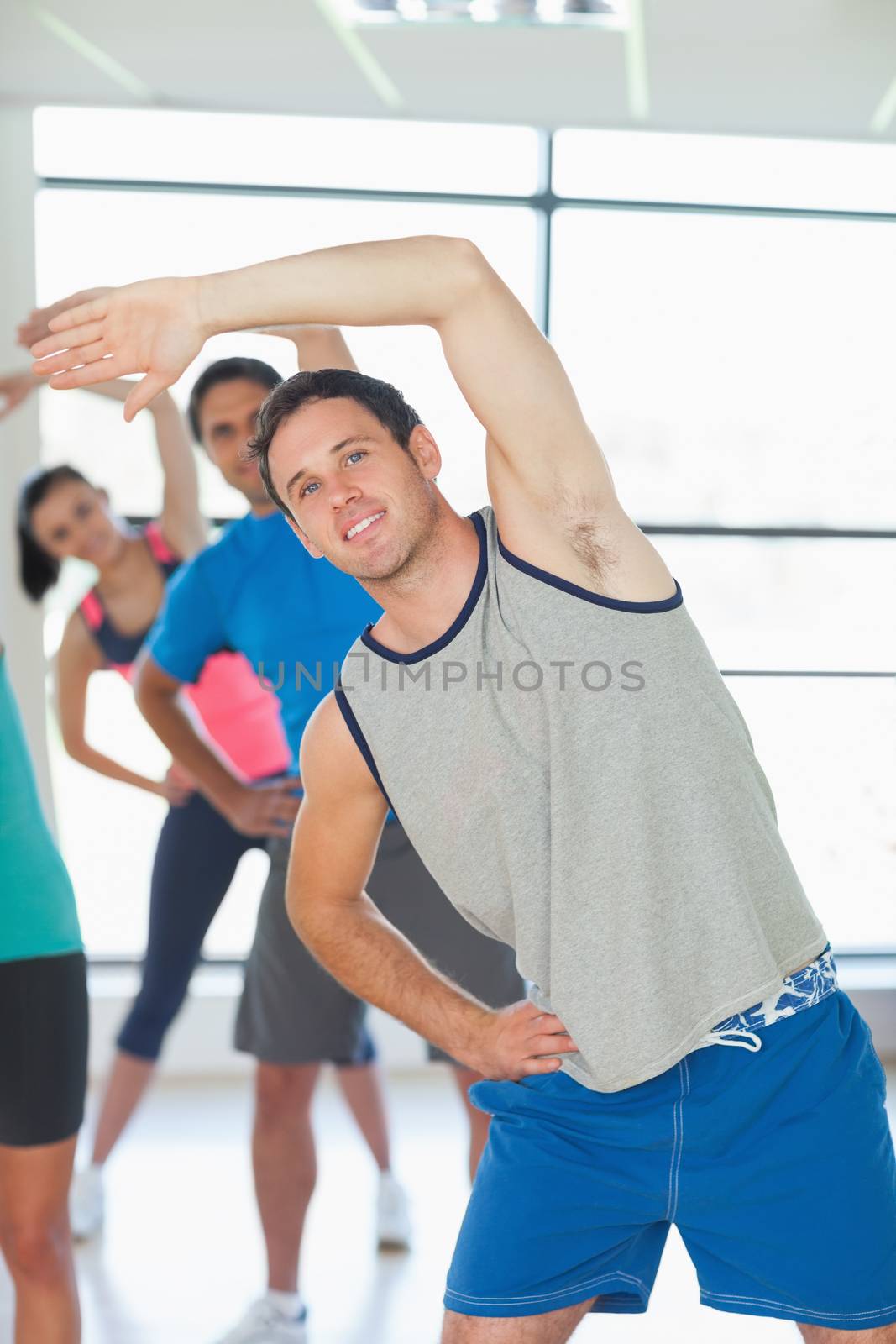 People doing power fitness exercise at yoga class by Wavebreakmedia