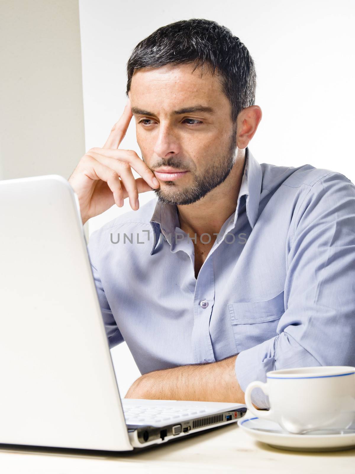 Young Man with Beard Working on Laptop isolated on a White Background
