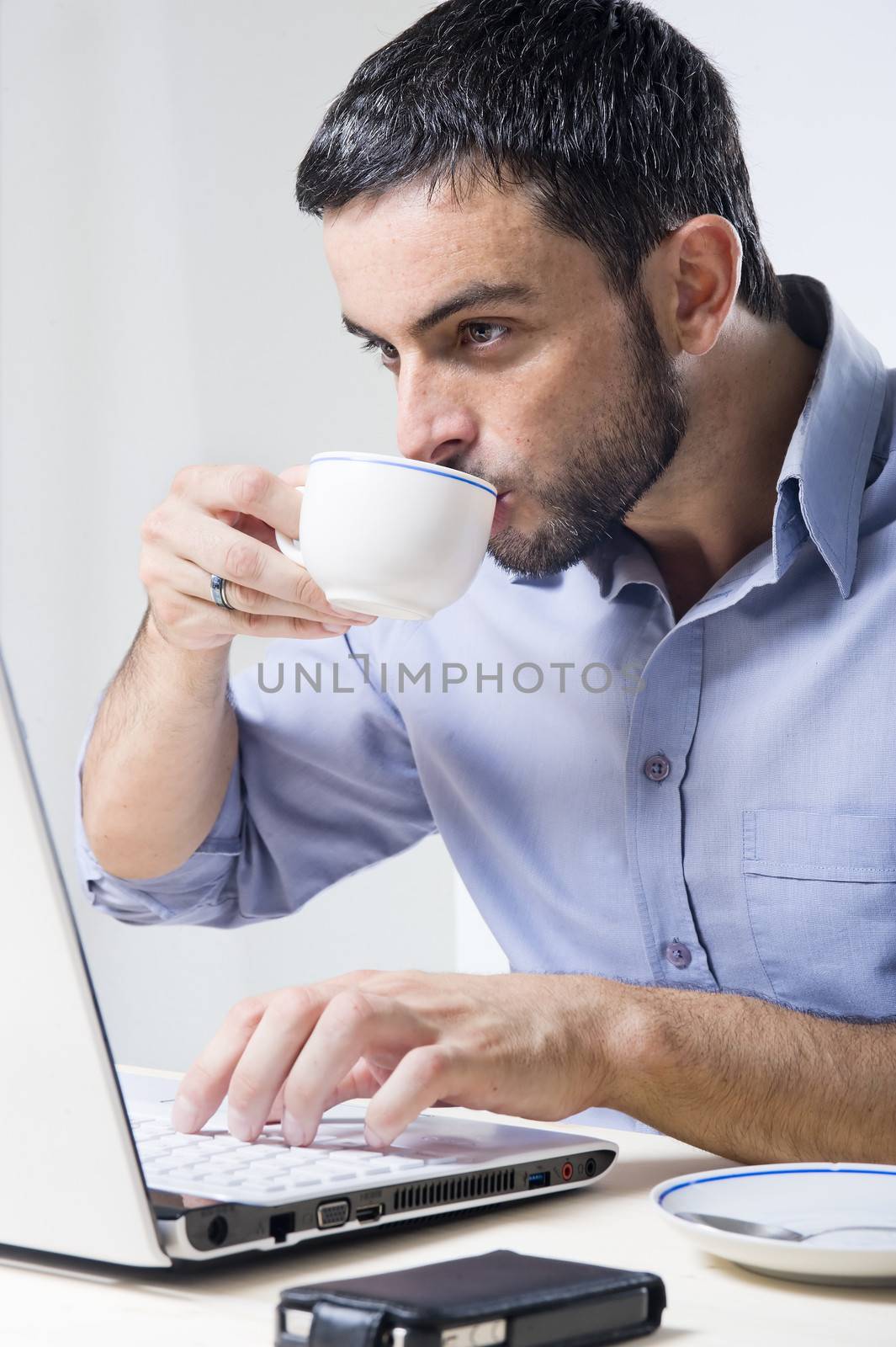 Young Man with Beard working on Laptop by ocusfocus