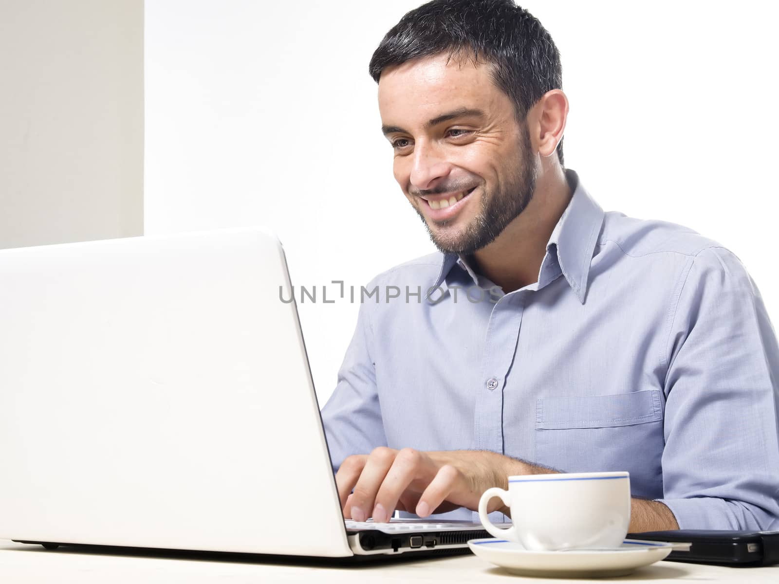 Young Man with Beard Working on Laptop isolated on a White Background