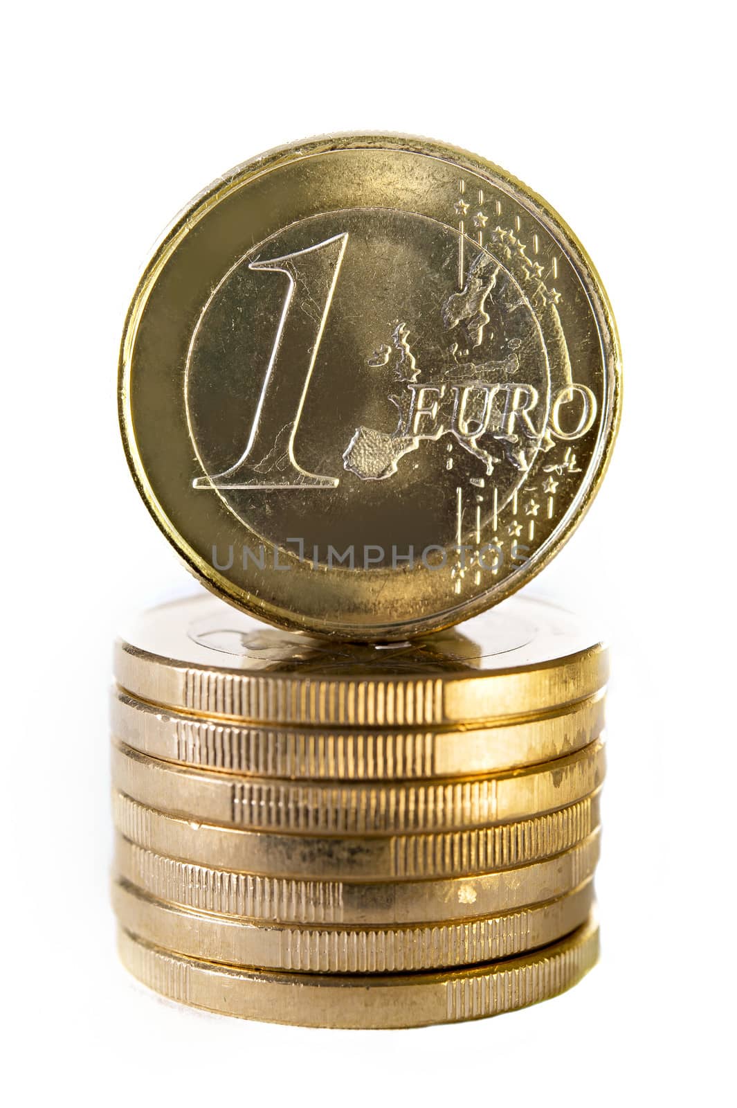 A stack of one Euro coins with one facing towards the camera isolated on white background