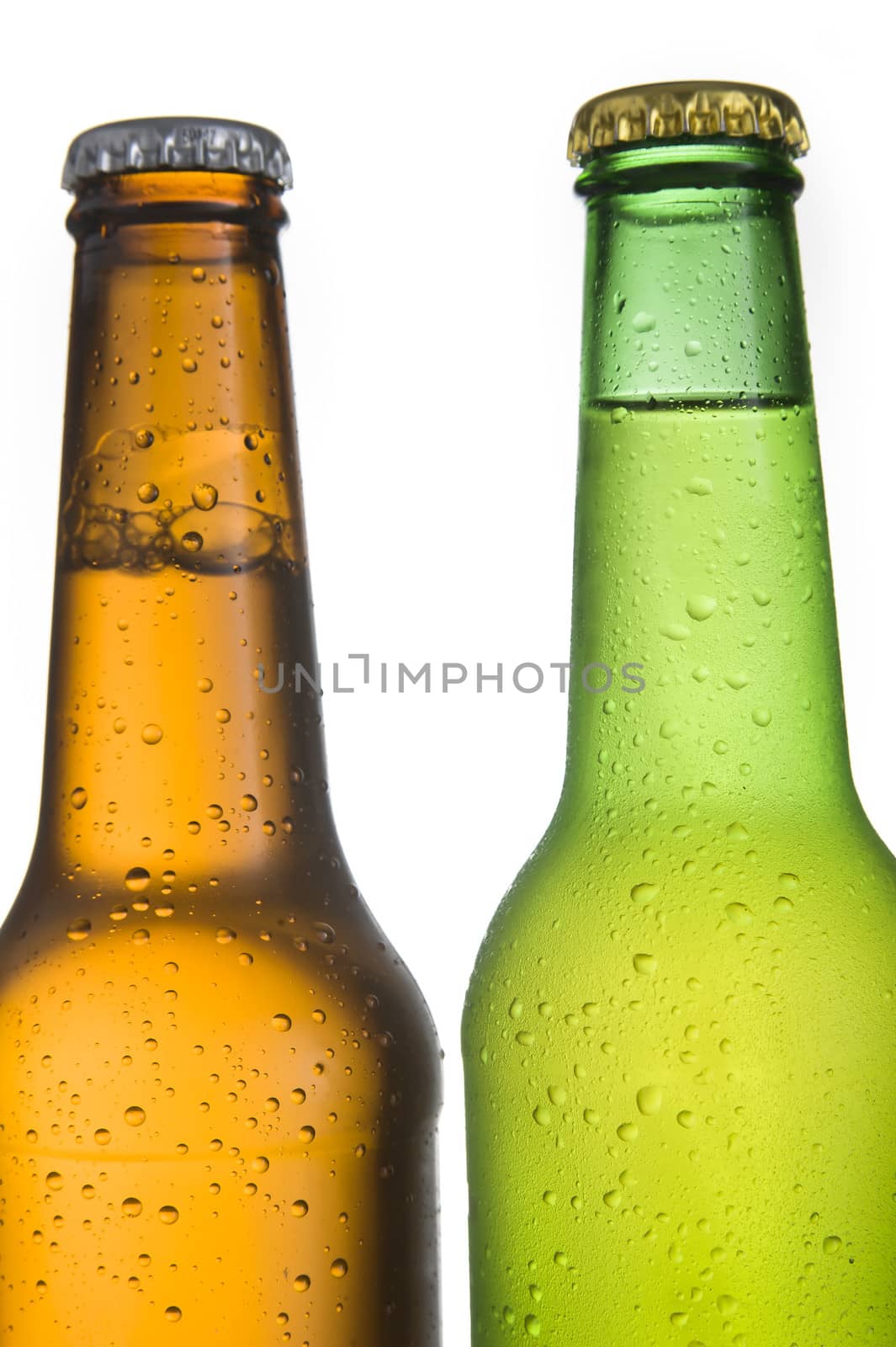 Close up of 2 Cold frosted beer bottles on white background.