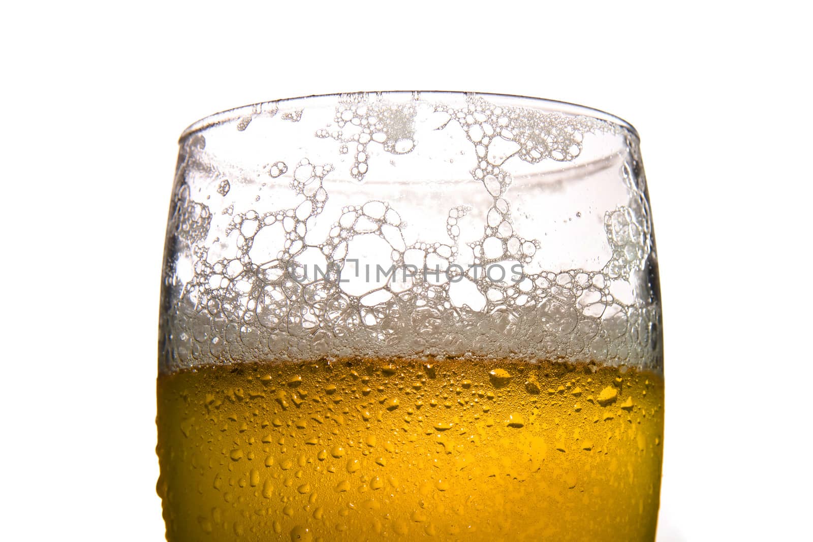 Cold frosted glass of beer on white background