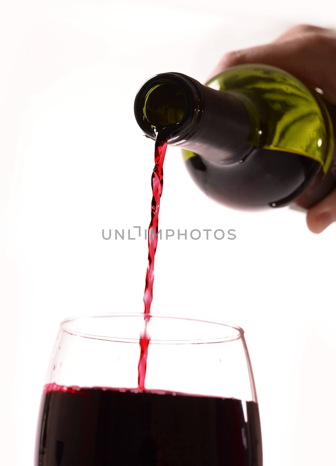 Man Hand holding Bottle filling Glass with Red Wine isolated on white background