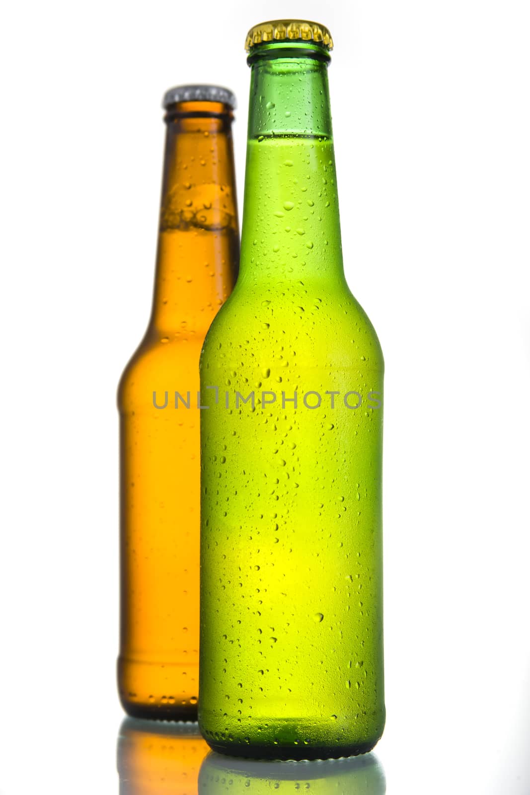 Close up of 2 Cold frosted beer bottles on white background.