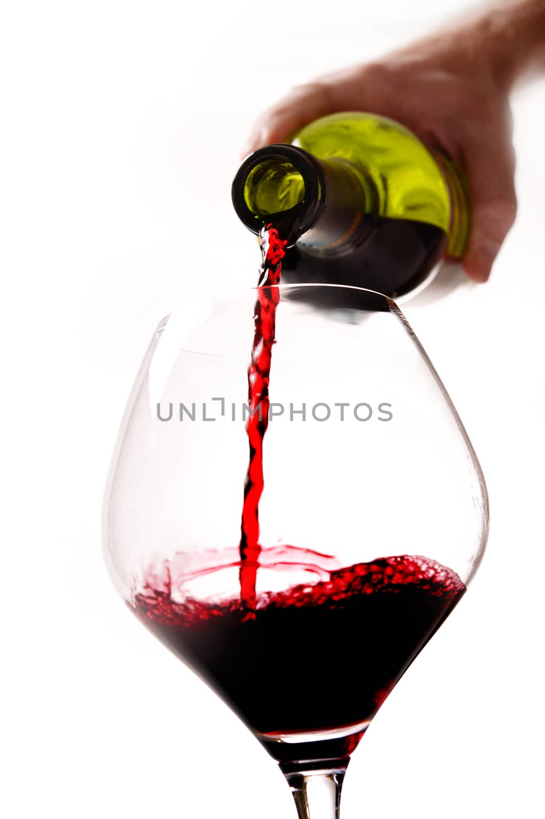 Man Hand holding Bottle filling Glass with Red Wine isolated on white background