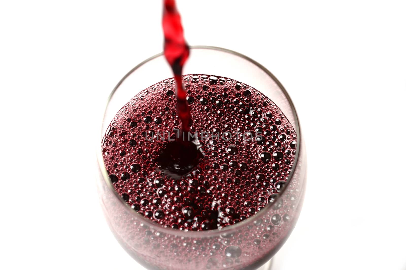 Red Wine stream poured on Glass by ocusfocus