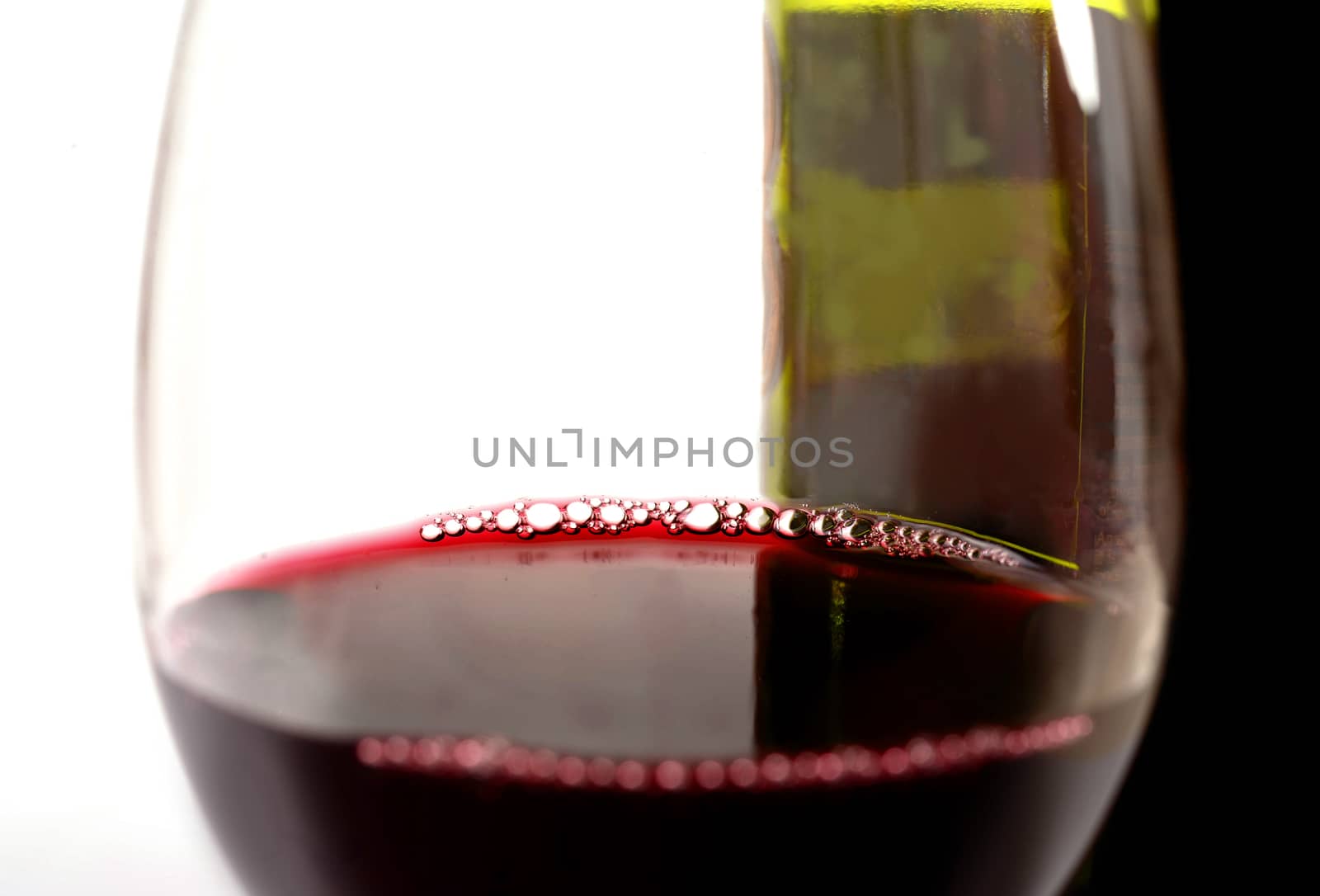 Close Up Glass of Red and Bottle  by ocusfocus