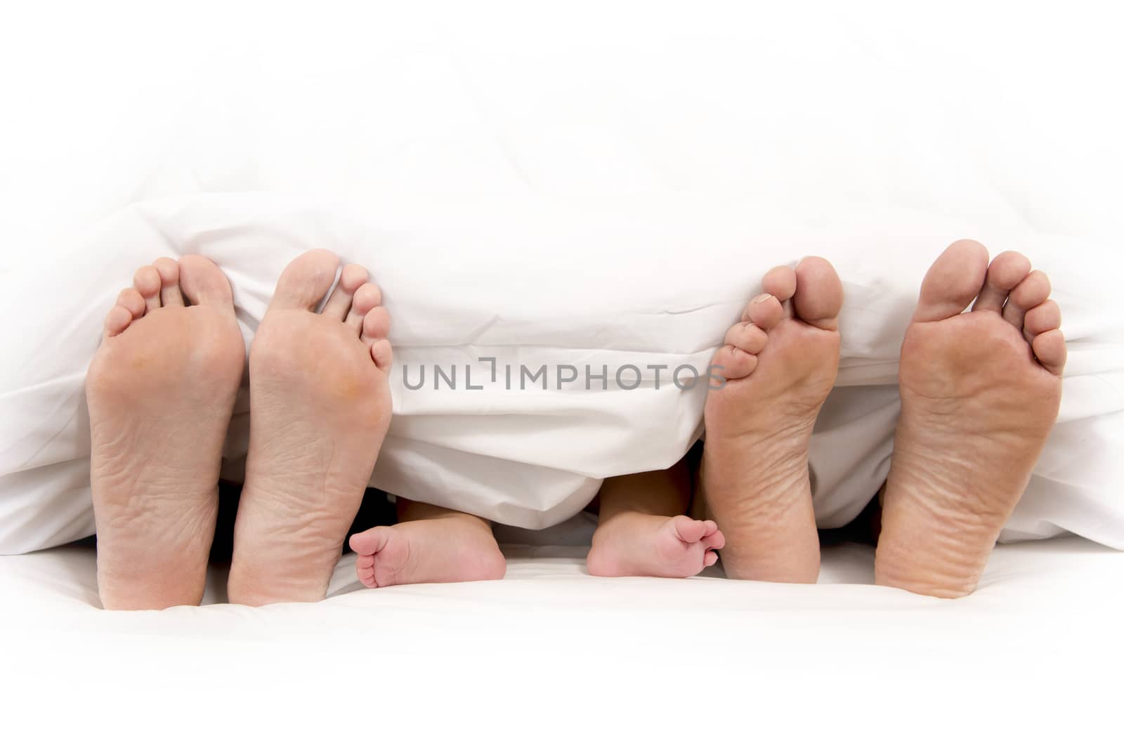 Mother Father and Baby Feet under Blanket isolated on white background