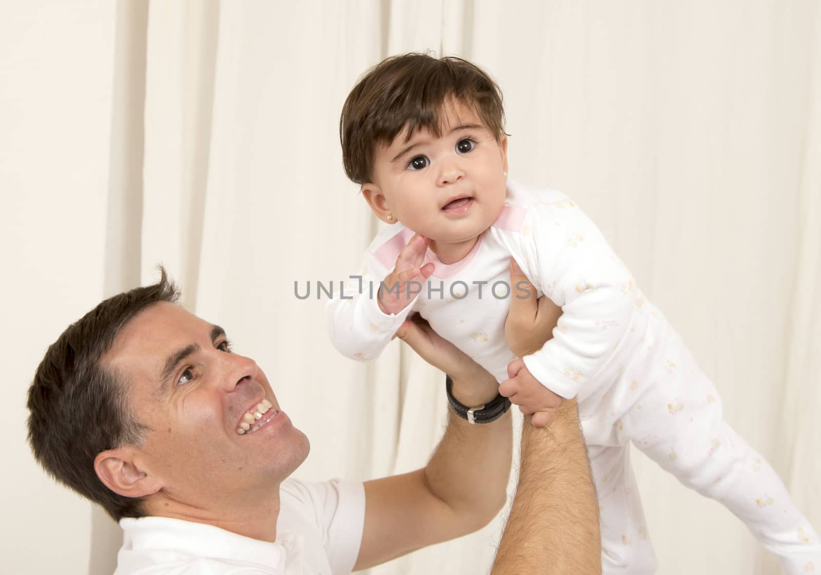 Father holding baby girl by ocusfocus