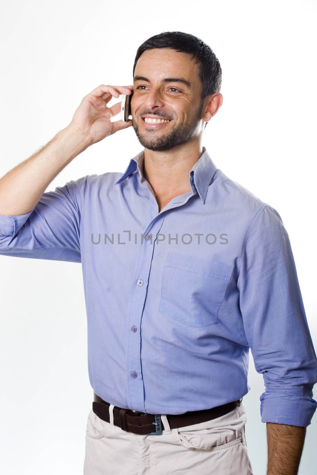 Happy Young Man with Beard Talking on Cellphone isolated on White Background