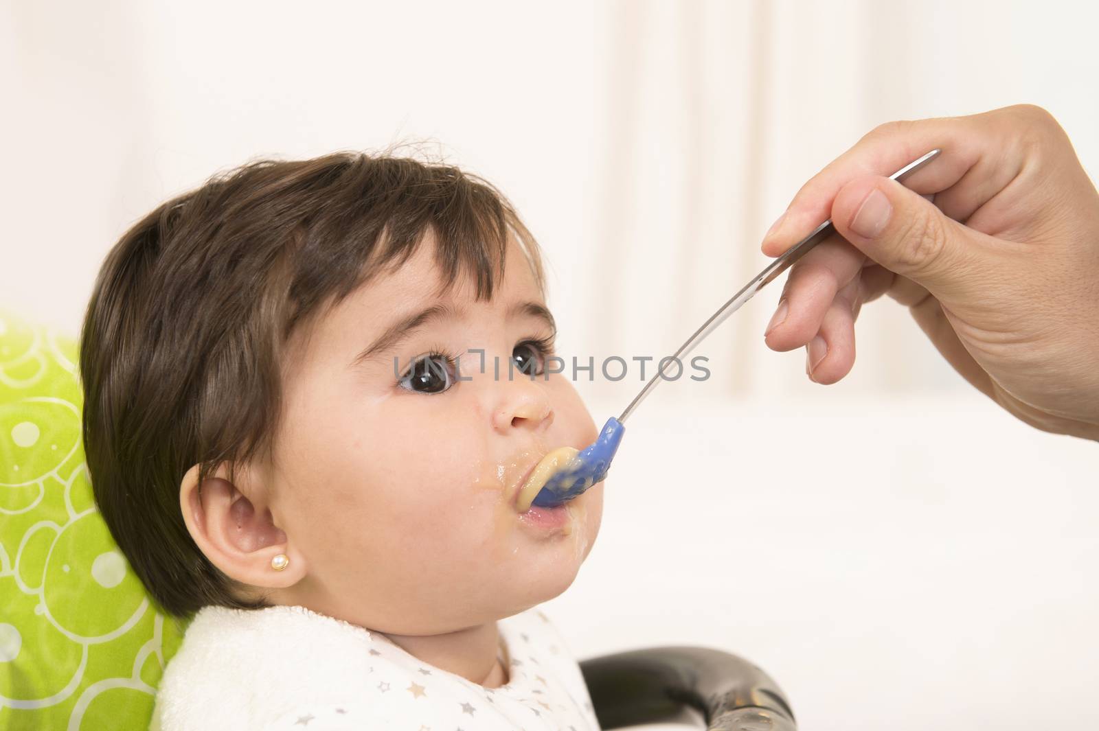 hand with spoon  Feeding cute Lovely Baby Girl 