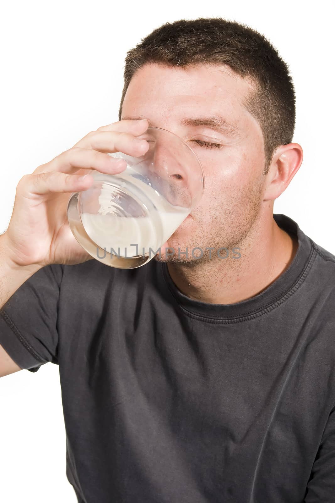 Healthy Young  Man drinking a Glass of Milk isolated on White Background