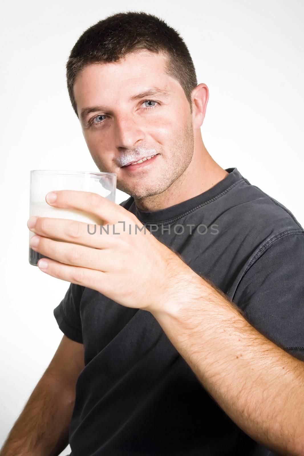 Happy Young  Man drinking Milk by ocusfocus