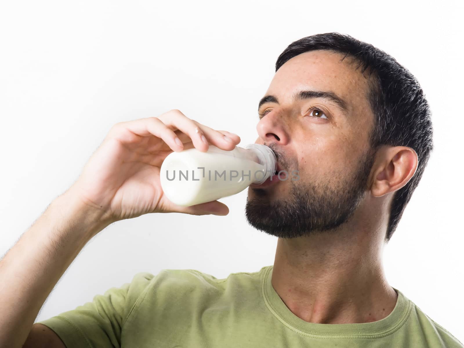 Young Handsome Man with Beard drinking Milk  by ocusfocus