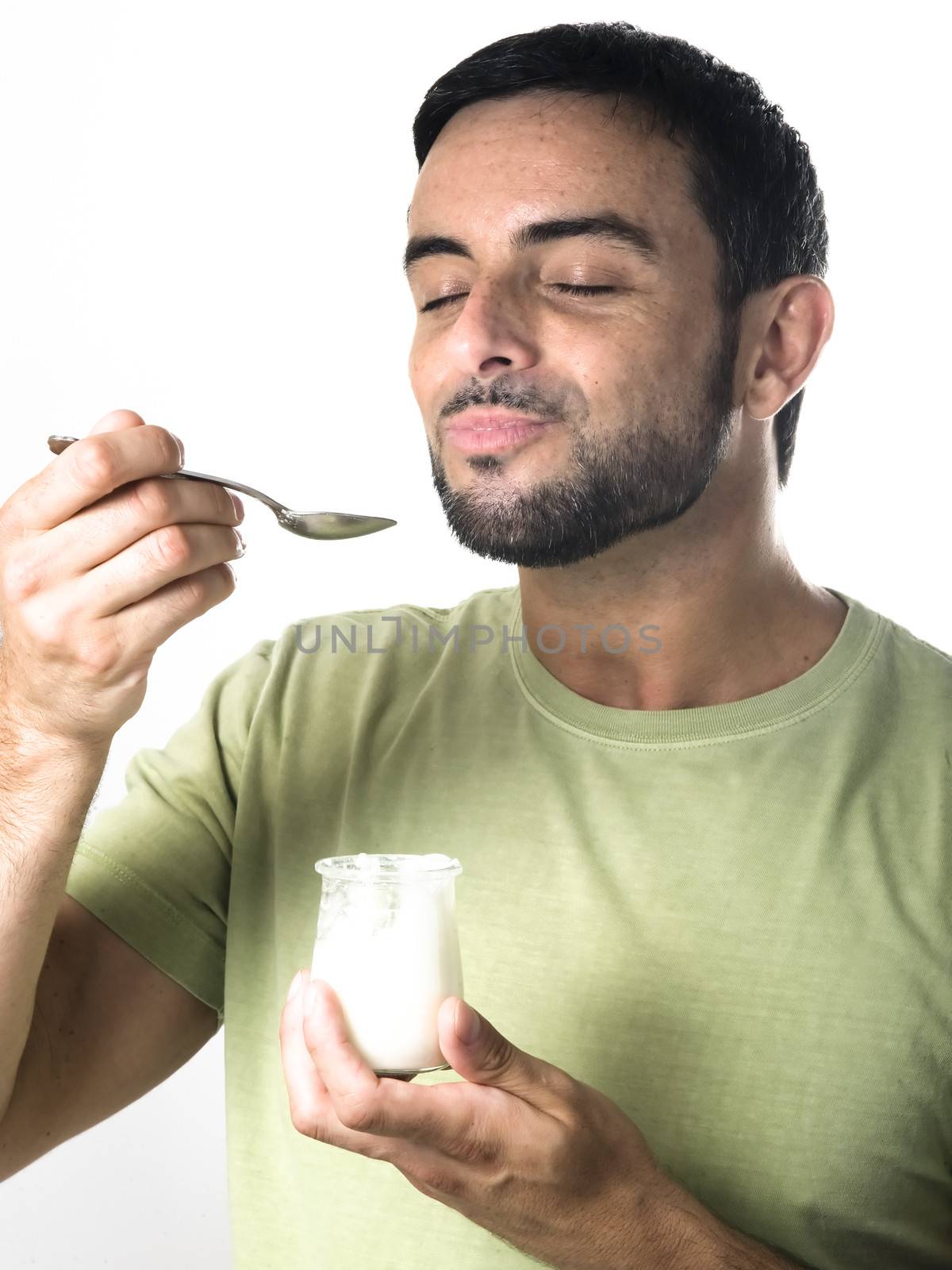 Happy Young Man with Beard Eating Yogurt Isolated on White Background