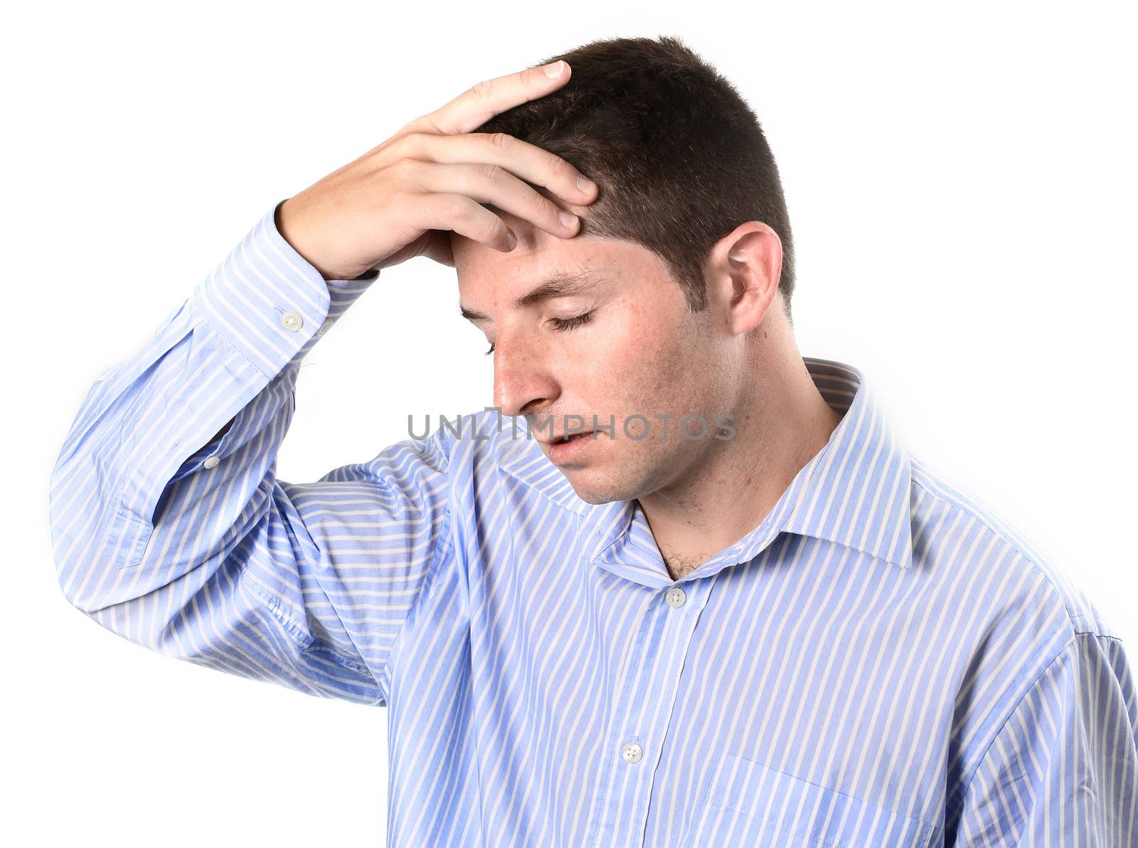 businessman wearing a blue business shirt is over worked and with a headache on a white background
