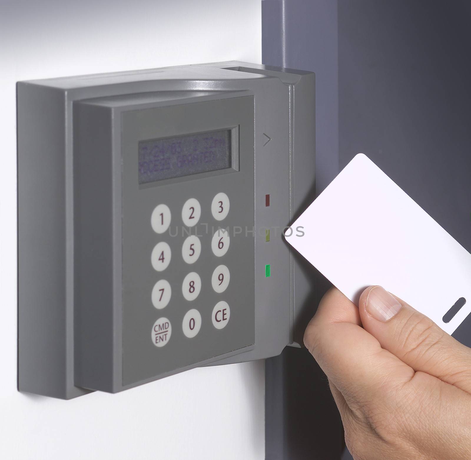 A hand inserting keycard in the electronic lock by f/2sumicron